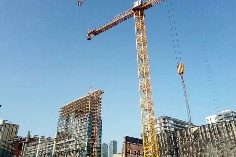 commercial plumbing job construction site large crane