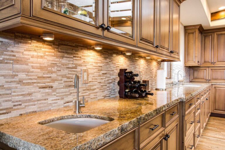 wooden cabinets kitchen with marble counter tops