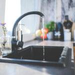 black kitchen sink running water